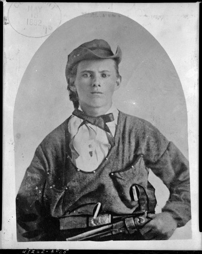 Jesse James, half-length portrait, facing front, holding handgun in left hand at his waist